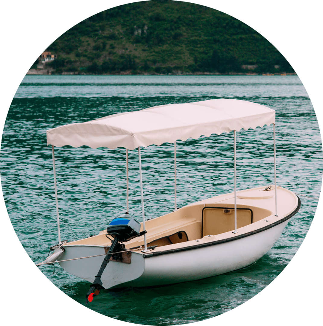 33 Small white motorboat with a canopy on calm water near a hilly shoreline.