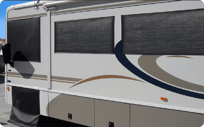 A large rv with windows on the side of it.