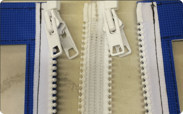 A close up of zippers on a sewing machine